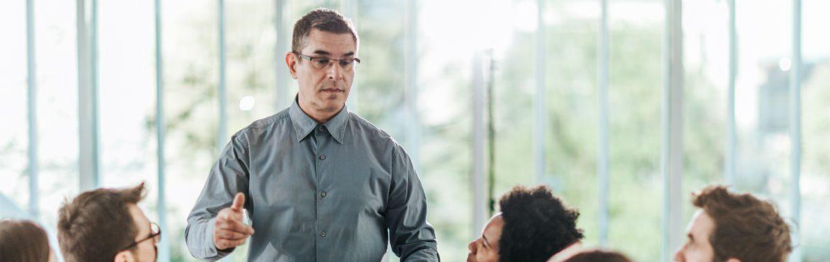 A crisis management consultant speaks to a corporate management team.